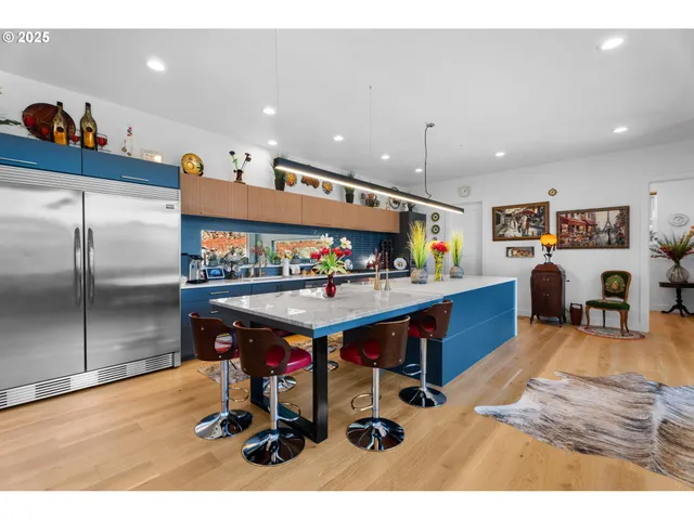 a living room with furniture a flat screen tv and a table