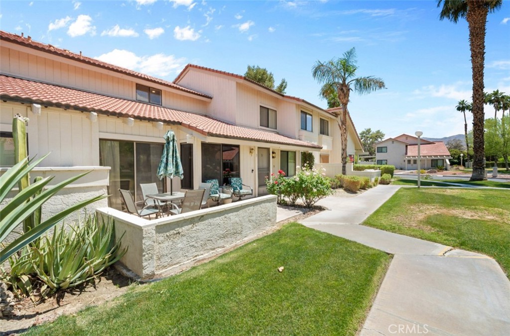 a view of a house with backyard porch and sitting area