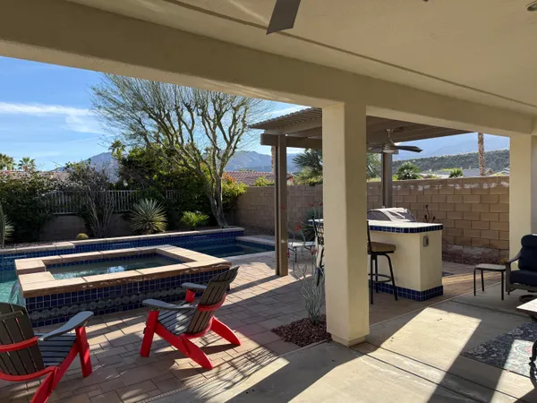 a view of swimming pool with lounge chair and potted plants