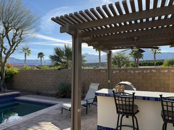 a patio view with a lake view and a potted plant