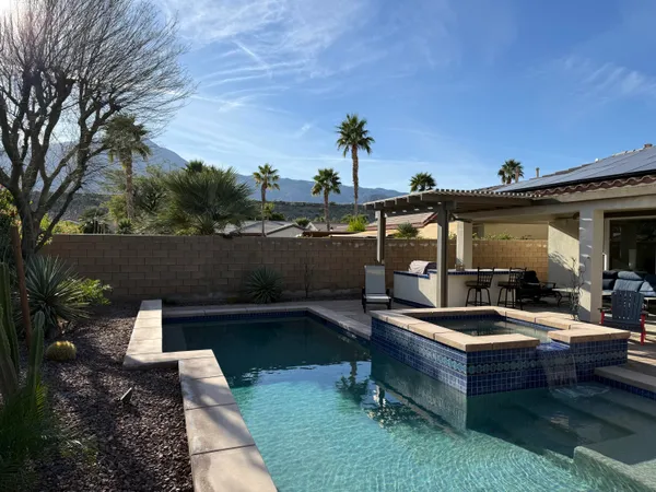 a view of swimming pool with outdoor seating