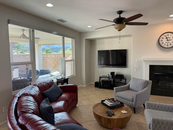 a living room with furniture a large window and a flat screen tv