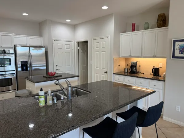 a kitchen with kitchen island stainless steel appliances a sink and counter space