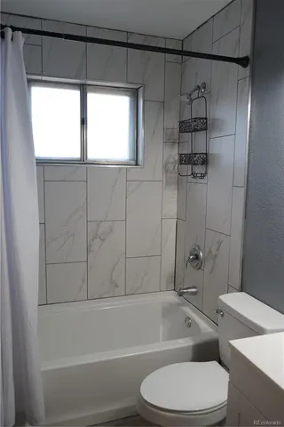 a bathroom with a toilet bathtub and shower