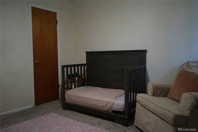 a bedroom with a bed and a chair