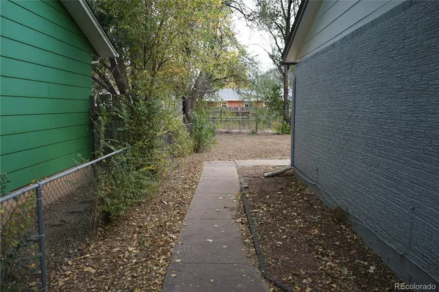 a view of a pathway both side of house