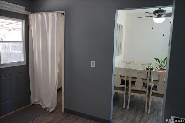 a view of a workspace with furniture and wooden floor
