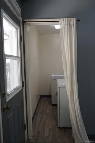 a view of a small space with wooden floor and a window