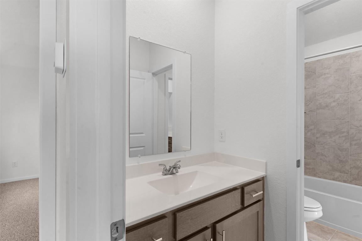 13821 Tucker Hedge Pass Elgin, TX 78621 - Photo 19 of 31 Full bathroom featuring vanity and washtub / shower combination