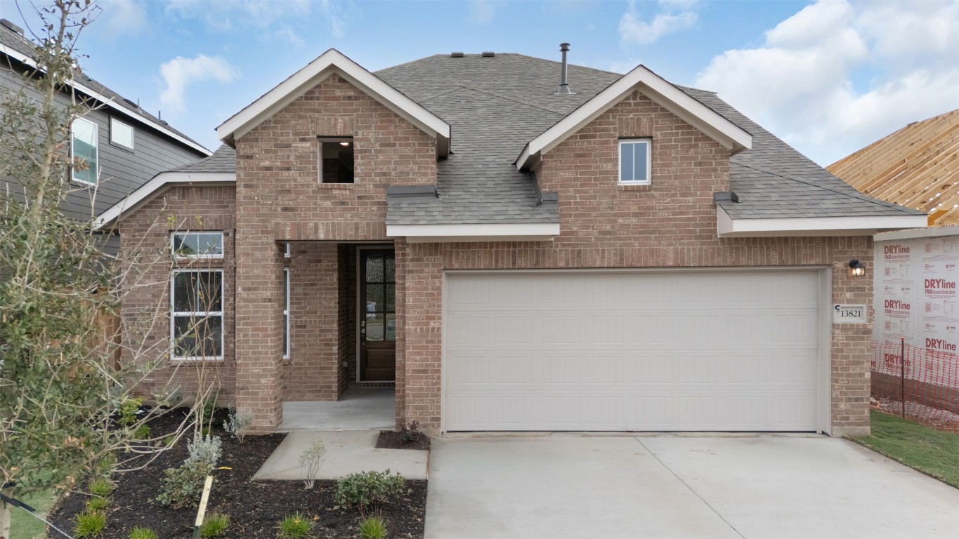 13821 Tucker Hedge Pass Elgin, TX 78621 - Photo 2 of 31 View of front of house with a shingled roof, brick siding, and concrete driveway