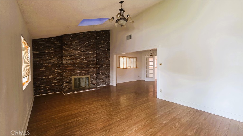 488 Royce Street Altadena, CA 91001 - Photo 2 of 10 a view of empty room with wooden floor and windows