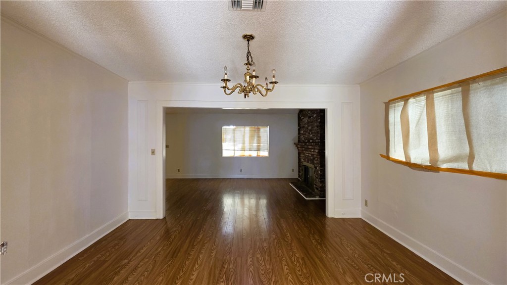 488 Royce Street Altadena, CA 91001 - Photo 3 of 10 a view of an empty room with wooden floor and a window