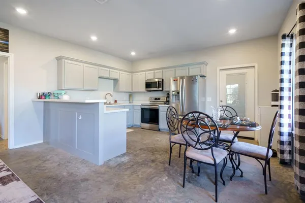 a kitchen with a sink a stove and cabinets