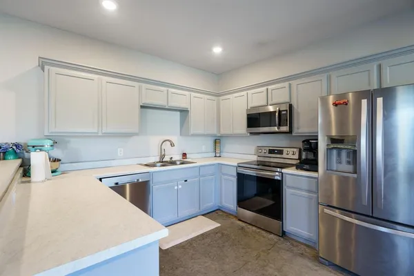 a kitchen with sink and cabinets