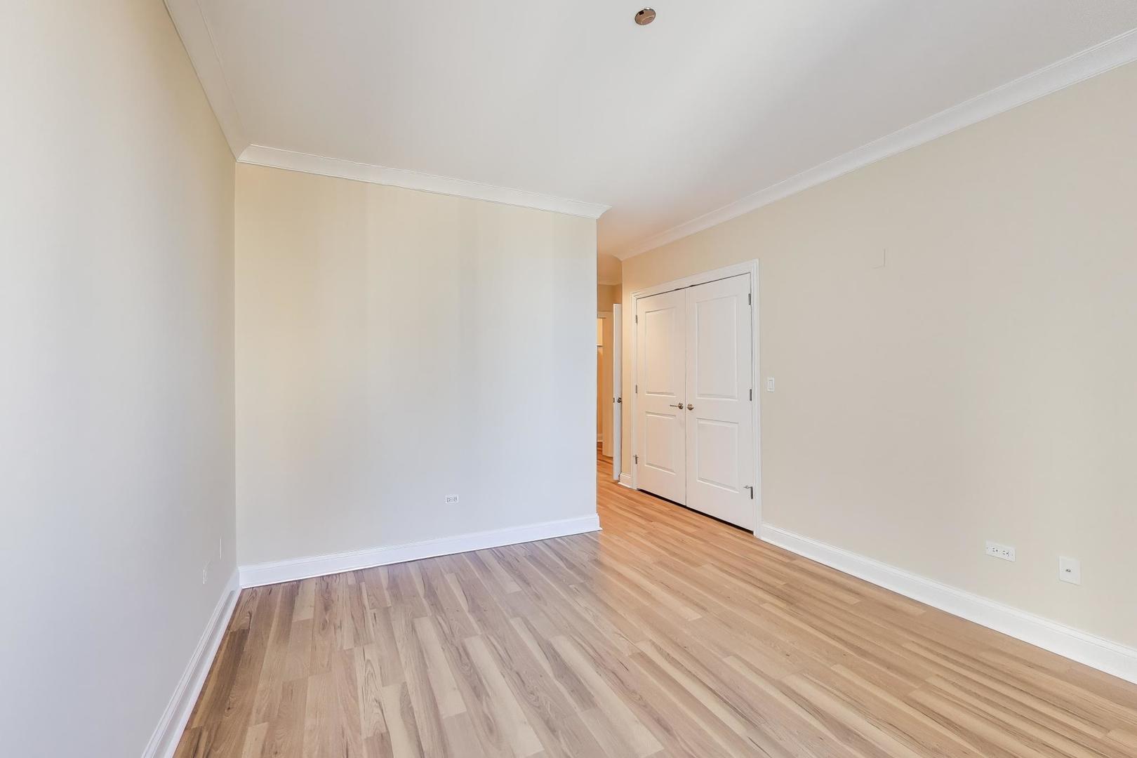 10 East Delaware Place, Unit 20A Chicago, IL 60611 - Photo 14 of 42 a view of an empty room with wooden floor