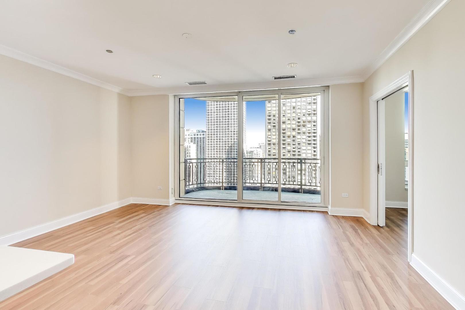 10 East Delaware Place, Unit 20A Chicago, IL 60611 - Photo 7 of 42 a view of an empty room with wooden floor and a window