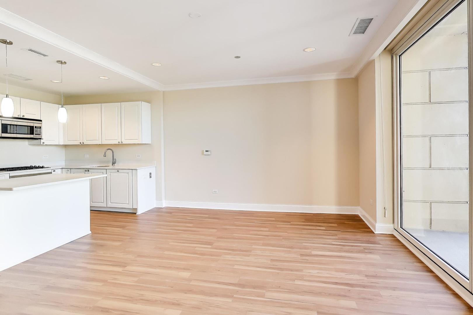 10 East Delaware Place, Unit 20A Chicago, IL 60611 - Photo 9 of 42 a view of kitchen with wooden floor and electronic appliances