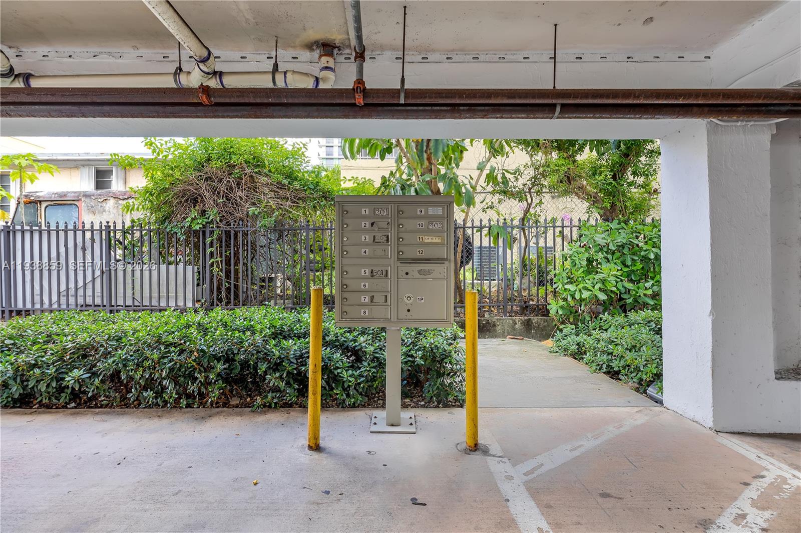 520 Southwest 5th Street, Unit 303 Miami, FL 33130 - Photo 18 of 20 a view of a street with a wooden fence