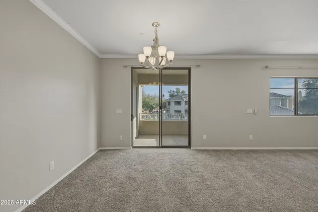 a view with double vanity sink a mirror and wooden cabinets