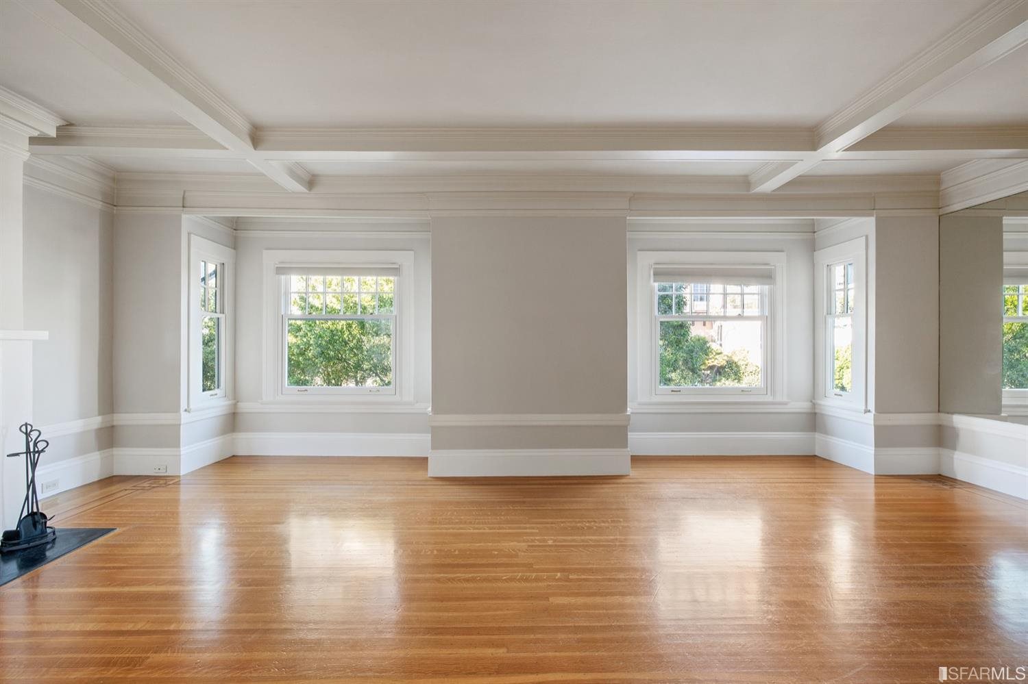 1069 Broadway San Francisco, CA 94133 - Photo 13 of 43 an empty room with wooden floor and windows
