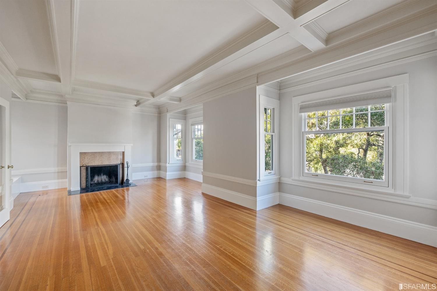 1069 Broadway San Francisco, CA 94133 - Photo 14 of 43 wooden floor fireplace and windows in an empty room