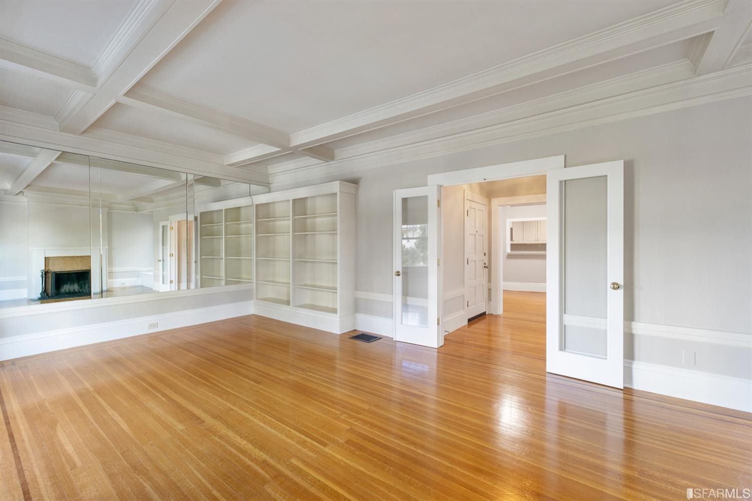 1069 Broadway San Francisco, CA 94133 - Photo 17 of 43 a view of an empty room with wooden floor and a window