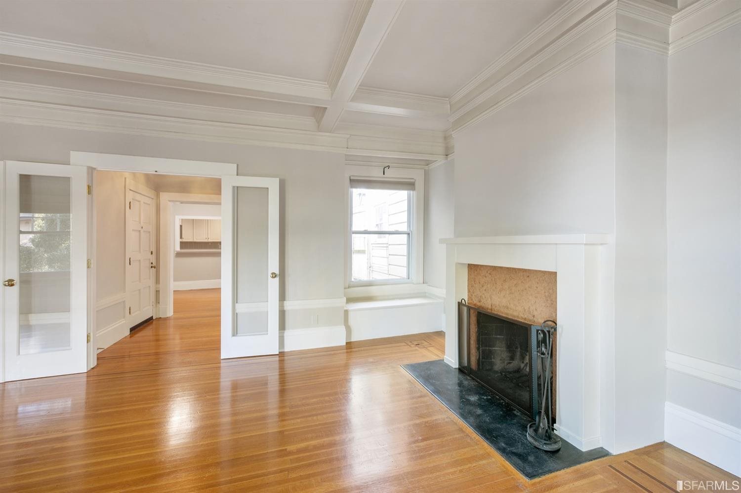 1069 Broadway San Francisco, CA 94133 - Photo 18 of 43 an empty room with wooden floor fireplace and windows
