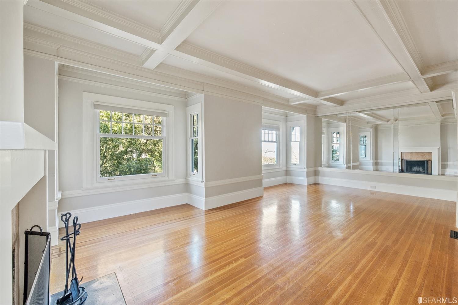 1069 Broadway San Francisco, CA 94133 - Photo 20 of 43 a view of an empty room with wooden floor and a window