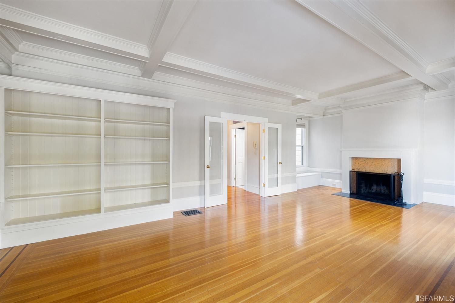 1069 Broadway San Francisco, CA 94133 - Photo 21 of 43 a view of an empty room with wooden floor and a window