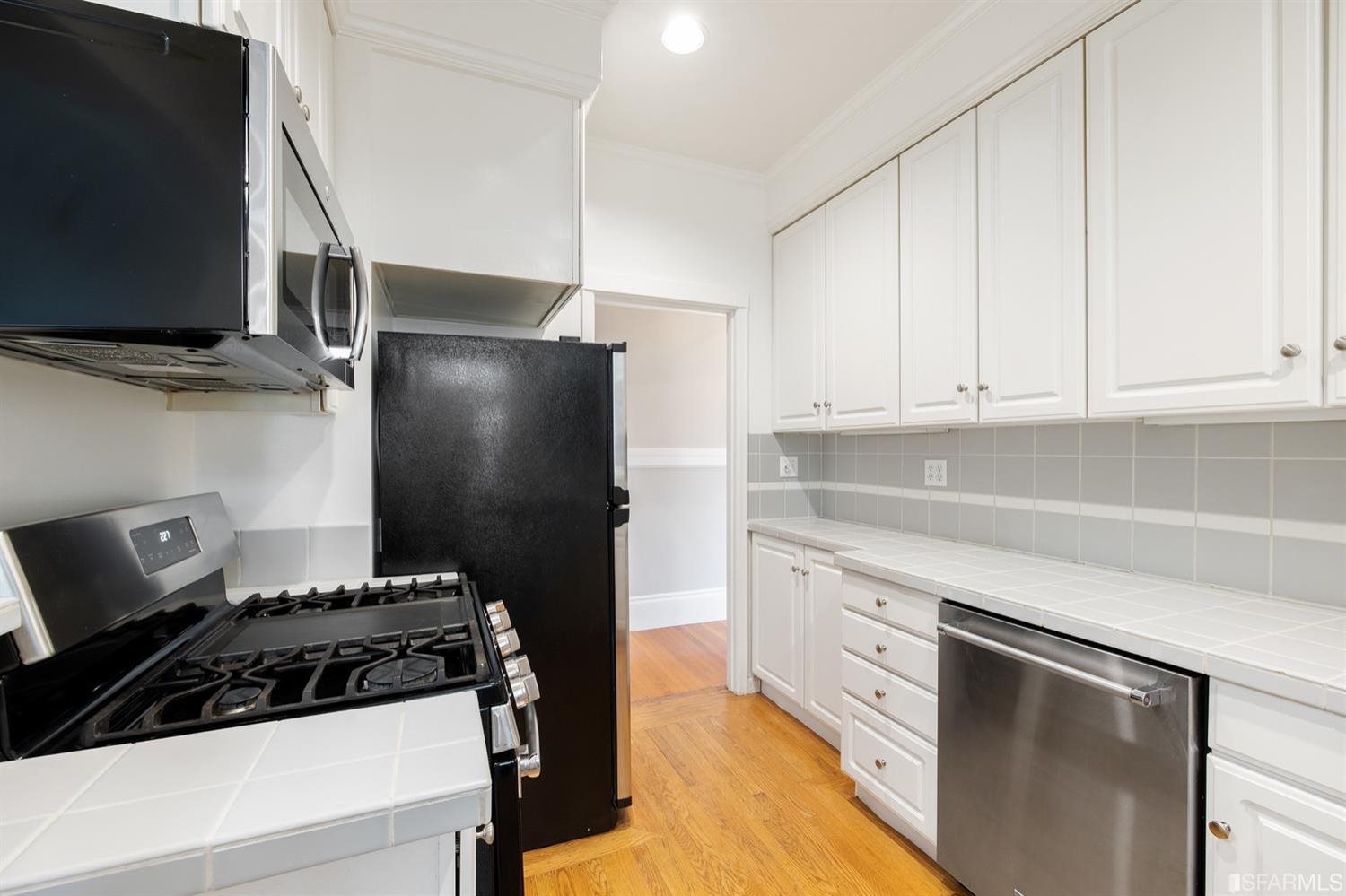 1069 Broadway San Francisco, CA 94133 - Photo 23 of 43 a kitchen with stainless steel appliances a stove and a refrigerator
