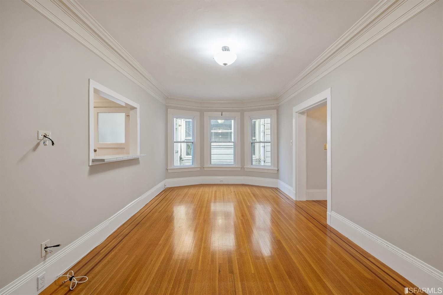 1069 Broadway San Francisco, CA 94133 - Photo 25 of 43 a view of an empty room with wooden floor and a window