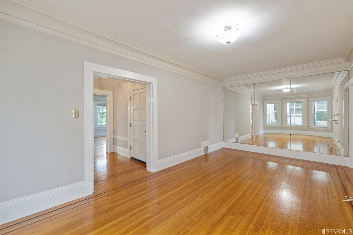 1069 Broadway San Francisco, CA 94133 - Photo 29 of 43 an empty room with wooden floor and windows