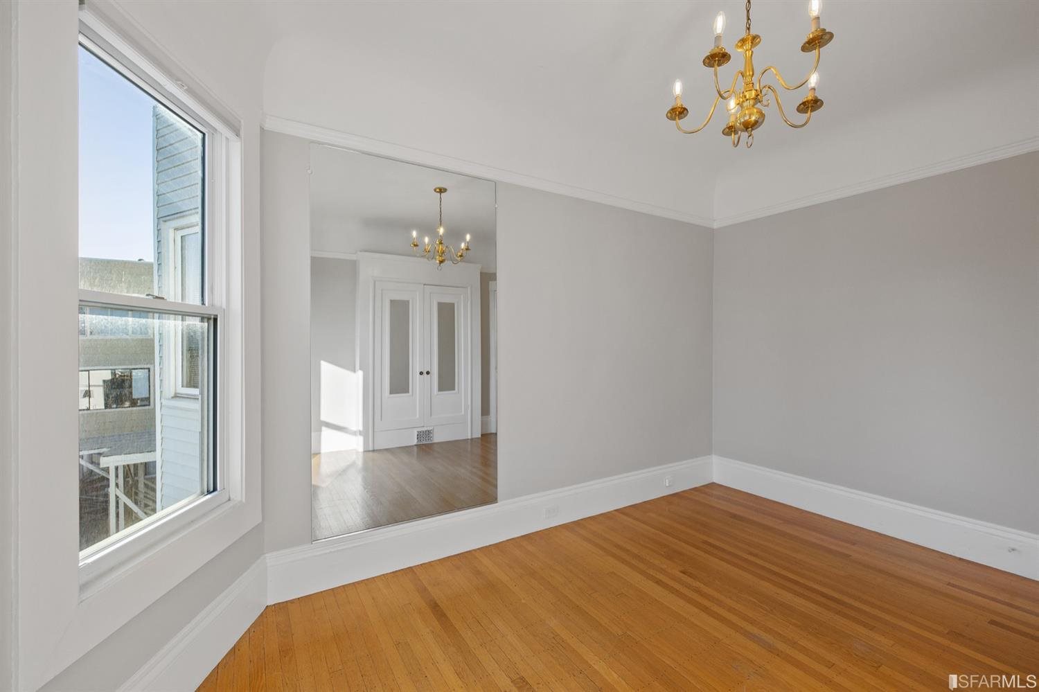 1069 Broadway San Francisco, CA 94133 - Photo 38 of 43 a bedroom with a bed and a window