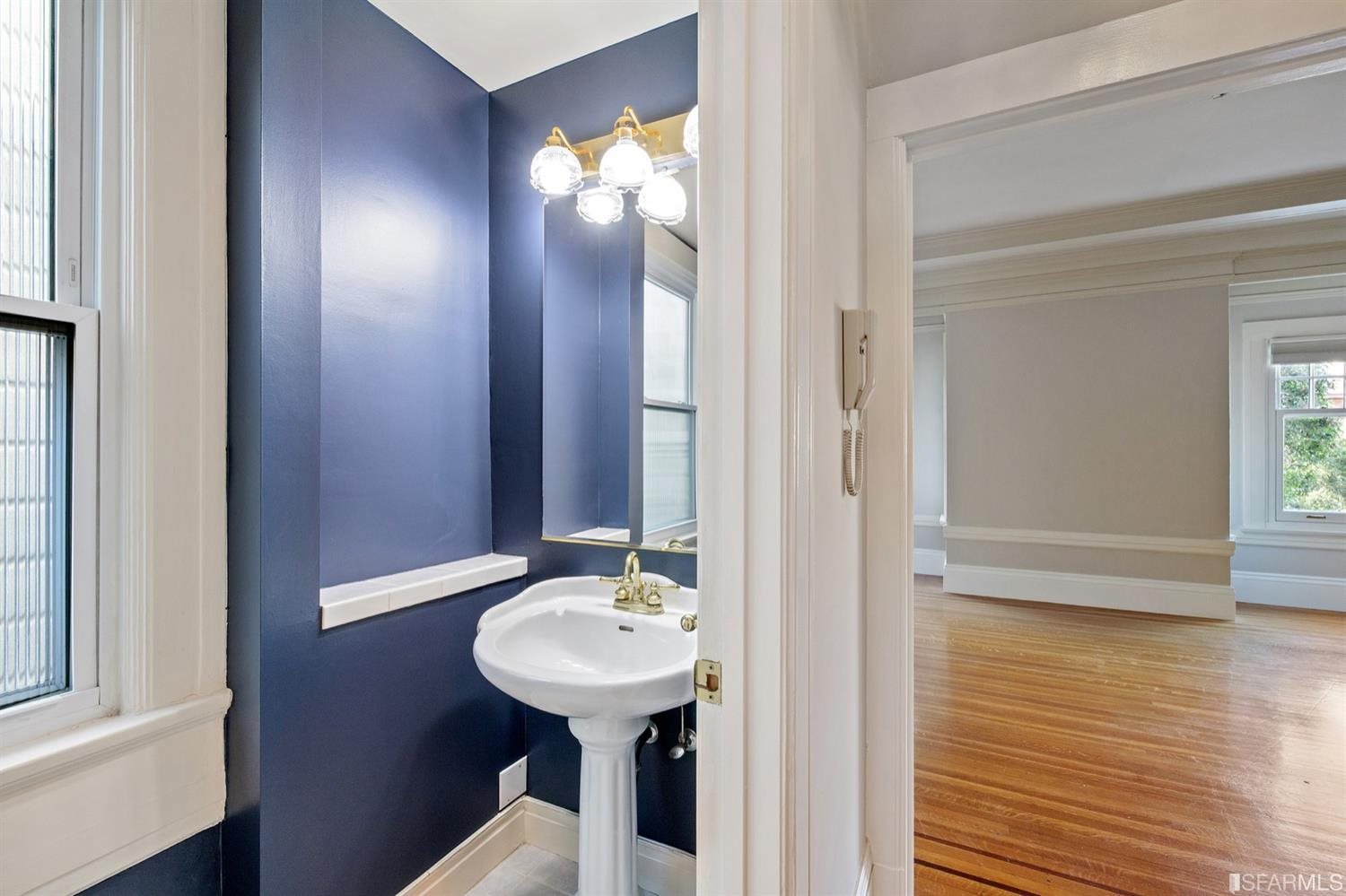 1069 Broadway San Francisco, CA 94133 - Photo 10 of 43 a bathroom with a sink and a mirror