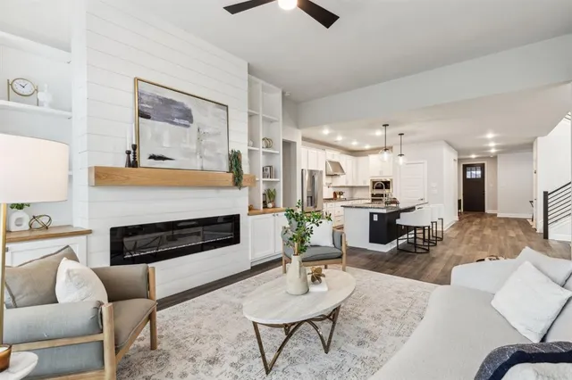 a living room with furniture kitchen view and a fireplace