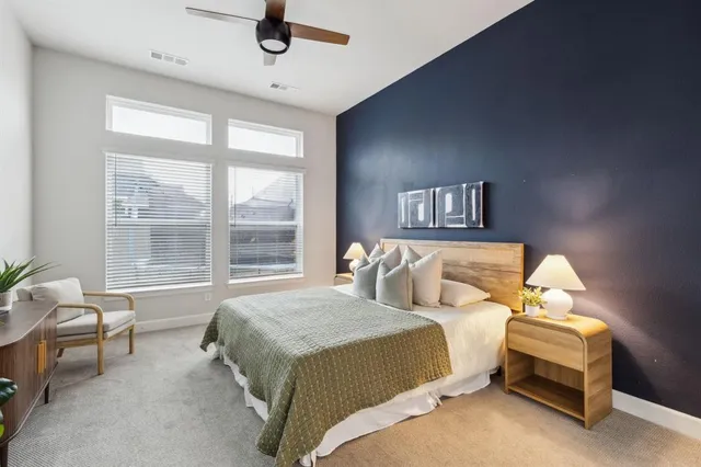 a bedroom with a bed a table and chair