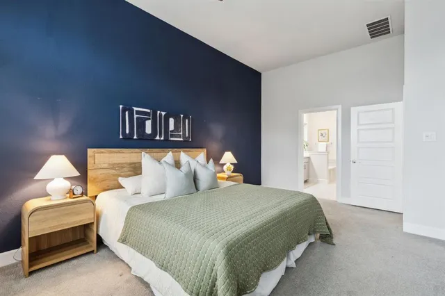 a bedroom with a bed and a lamp