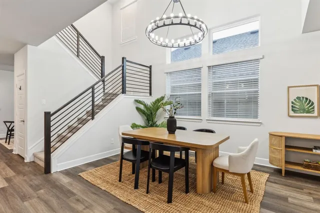 a dining room with furniture a chandelier and wooden floor