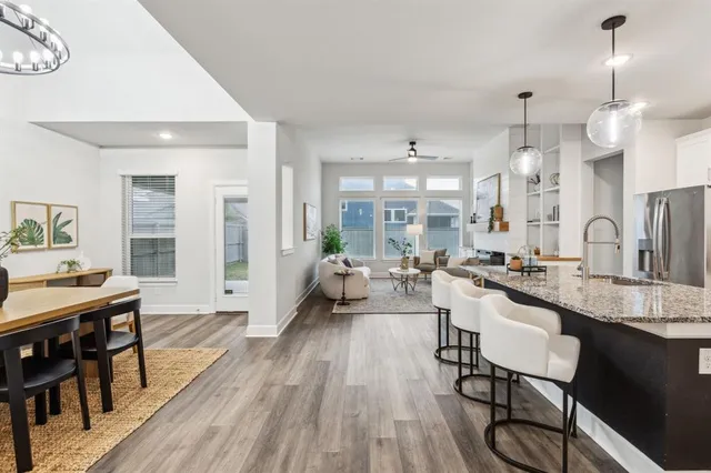 a large kitchen with a table and chairs in it