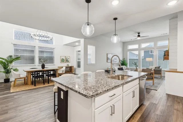 a kitchen with center island table and chairs