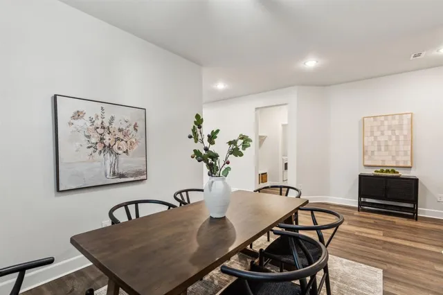 a view of a a dining room with furniture window and wooden floor