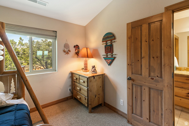 755 South Zion Ridge Drive Orderville, UT 84758 - Photo 64 of 84 Bedroom with lofted ceiling and light colored carpet