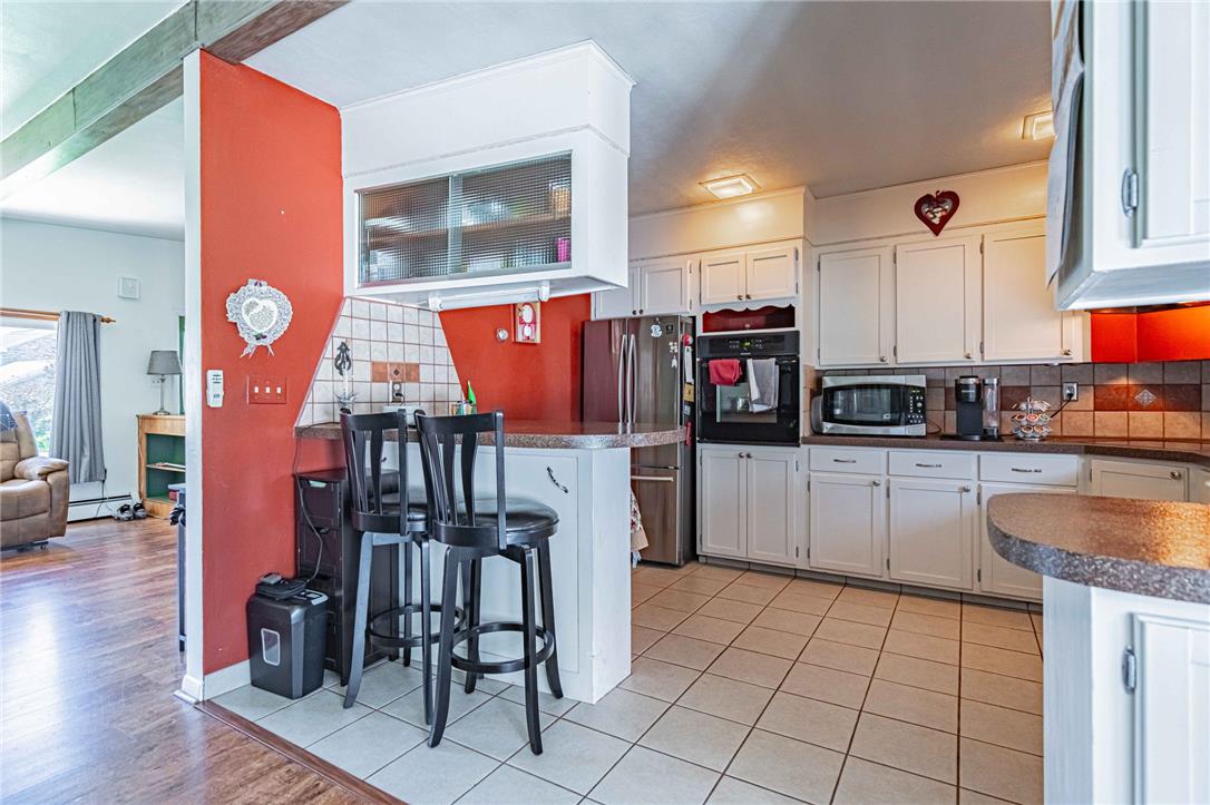 579 Cherry Road Northampton, PA 18067 - Photo 18 of 57 A well-appointed kitchen showcasing white cabinetry and a convenient breakfast bar for casual dining.