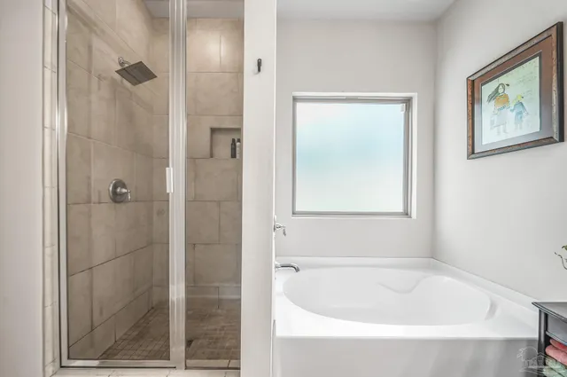 a bathroom with a bathtub and shower