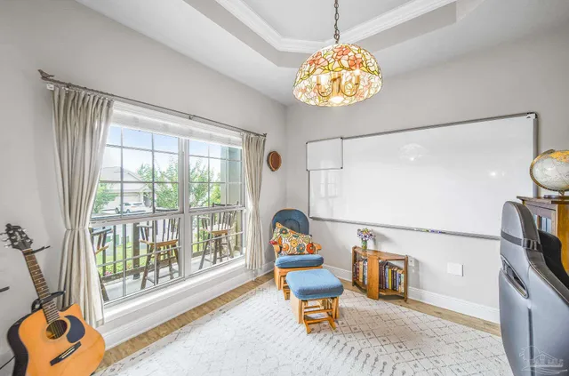 a dining room with furniture a chandelier and a window