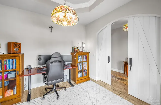 a view of a workspace with furniture and a bookshelf