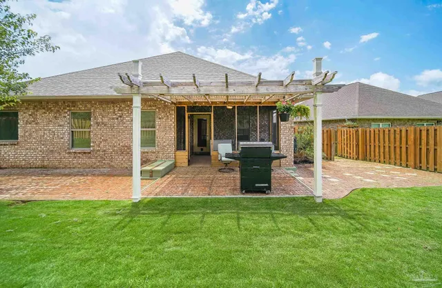 a view of a house with a yard and sitting area