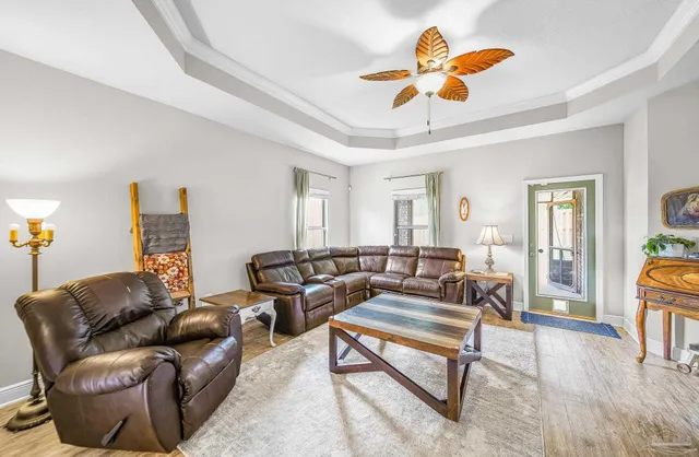 a living room with furniture ceiling fan and a rug