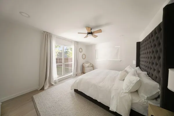a bedroom with a bed and a large window