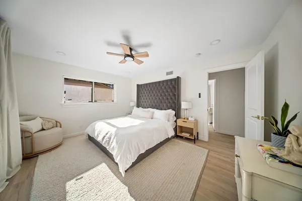 a bedroom with a bed couch and window